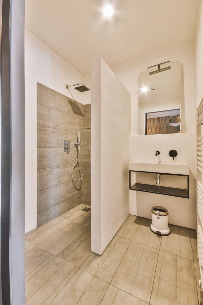 Sink with tap installed on tabletop near mirror and door in contemporary bathroom at home